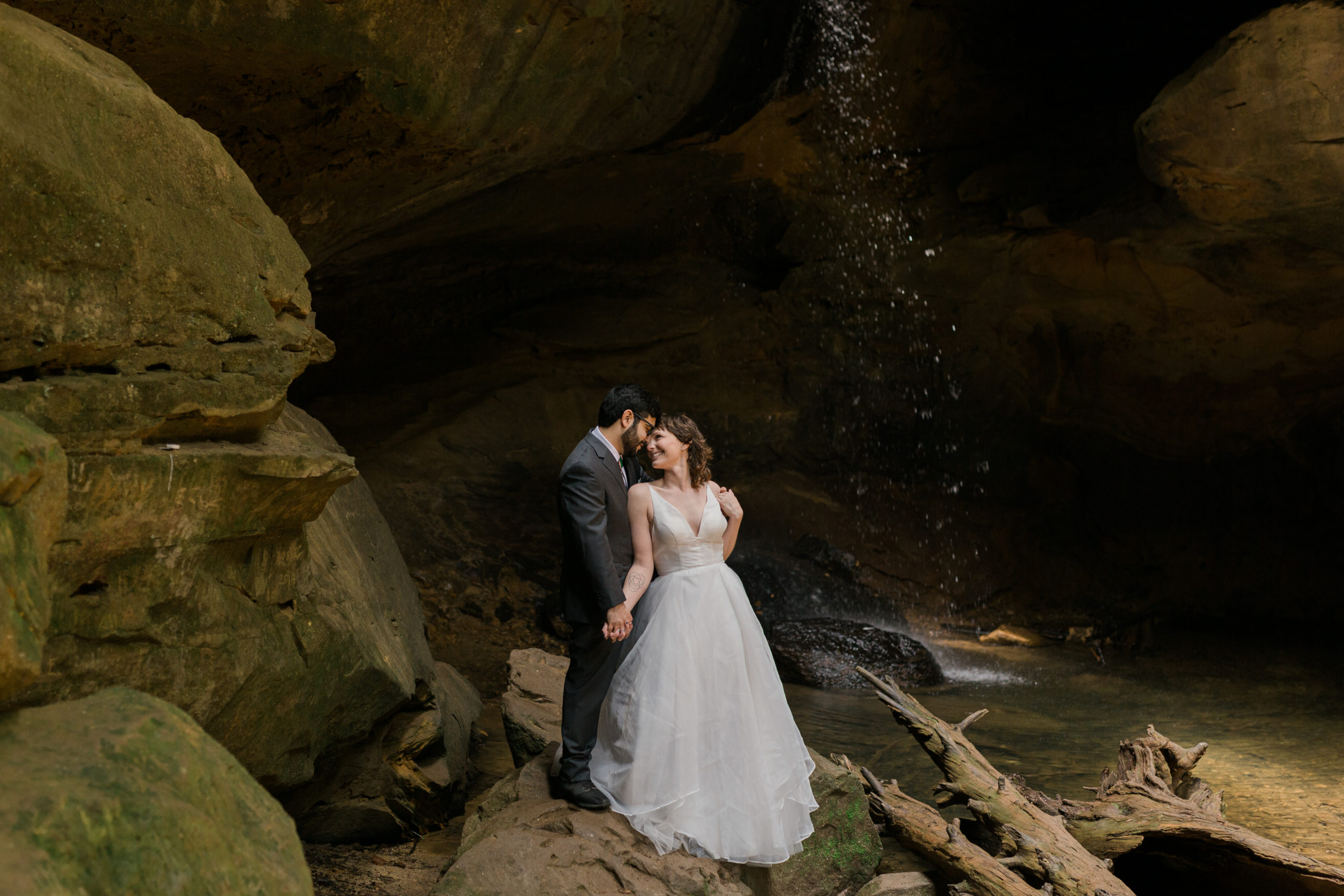 A couple staring at each other by the waterfall in Hocking Hills, Ohio